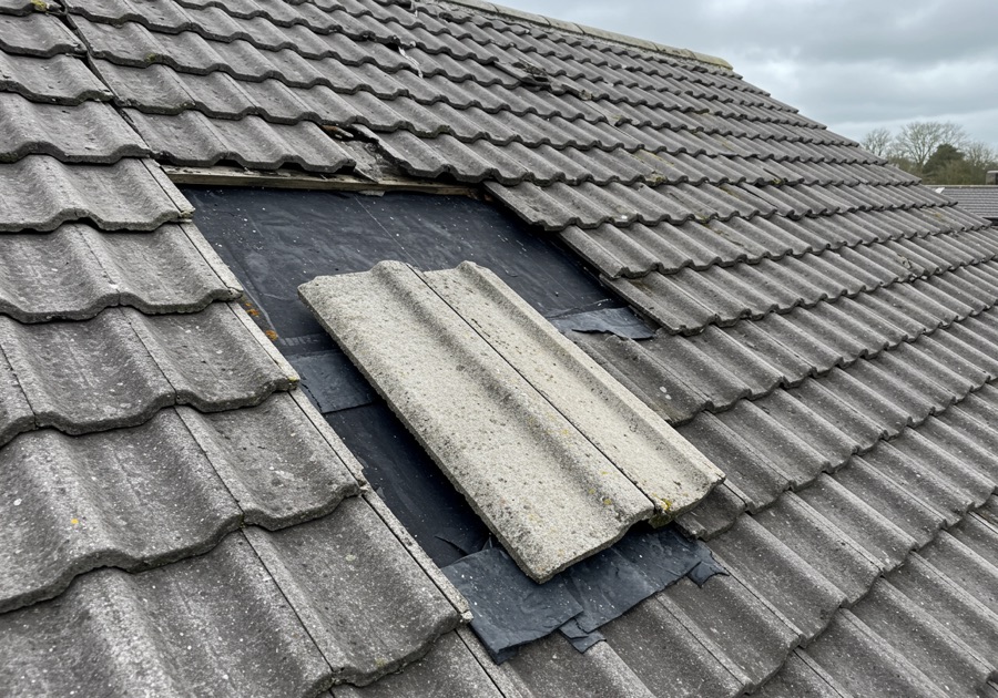 Illustrative AI-generated example of a concrete interlocking roof tile that has slipped, exposing the underlay and batten beneath